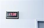 Digital clock on wall, low angle view