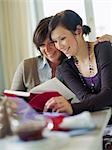 Mother and daughter looking in a book