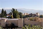 View from the Albaicin across the Arab walls of the Ziri Fortress to the Alhambra and Sierra Nevada mountains, Granada, Andalucia, Spain, Europe