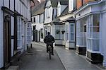 Man cycling along narrow street, Alcester, Warwickshire, Midlands, England, United Kingdom, Europe