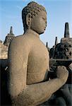 Side view of Buddha image sitting in open chamber with stupas in background, Borobudur Temple, UNESCO World Heritage Site, island of Java, Indonesia, Southeast Asia, Asia