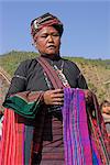 Ann lady with textiles in Ann village, Kengtung (Kyaing Tong), Shan state, Myanmar (Burma), Asia