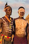 Karo men with body painting, made from mixing animal pigments with clay, at dancing performance, Kolcho village, Lower Omo valley, Ethiopia, Africa