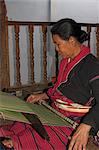 Paulaung lady weaving on balcony of her house, Wan Pauk village (Paulaung tribe), Kengtung (Kyaing Tong), Shan state, Myanmar (Burma), Asia