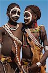 Two Hamer (Hamar) girls wearing traditional goat skin dress decorated with cowie shells, Dombo Village, Turmi, Lower Omo Valley, Ethiopia, Africa