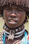 Banna woman wearing a necklace known as a bignere, a metal band with a phallic protuberance to signify she is a first wife, at the weekly market, Key Afir, Lower Omo Valley, Ethiopia, Africa