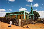 Lady walking past mosque, Konso, southern area, Ethiopia, Africa