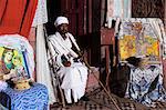 Priest holding cross inside Bet Gabriel-Rufael, Lalibela, Ethiopia, Africa