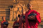 Novice Monks holding alms bowls at Mingun Paya, Mingun, Mandalay, Myanmar (Burma), Asia