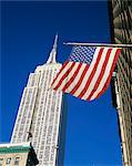 The American flag, the stars and stripes in front of the Empire State Building in New York, United States of America, North America