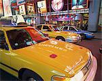 Yellow cabs on the street at night in Times Square, with Virgin Megastore in the background, in New York, United States of America, North America