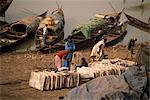 Blocks of salt on river bank, with pirogues in background, Mopti, Mali, West Africa, Africa