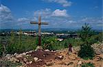 Cross and pilgrim on Apparition Hill, with town beyond, Medjugorje, Bosnia Herzegovina, Europe