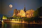 Notre Dame Cathedral at night, with moon rising above, Paris, France, Europe