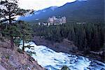 Banff, the Bow Falls and prestigious Banff Springs Hotel, at dusk, Banff National Park, UNESCO World Heritage Site, Alberta, Canada, North America