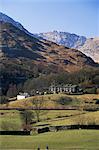 View across fields to cottages and snow-capped mountains, Little Langdale, Lake District National Park, Cumbria, England, United Kingdom (U.K.), Europe