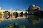 View across River Tiber to the Ponte Sant'Angelo and Castel Sant'Angelo, Rome, Lazio, Italy, Europe