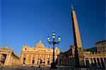 The facade of St. Peter's basilica at sunrise, with lamp-post and obelisk, St. Peter's Square (Piazza San Pietro), Vatican City, Rome, Lazio, Italy, Europe