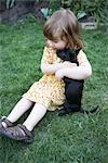 Little Girl Playing With a Puppy