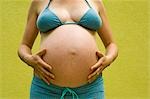 Woman, Nine Months Pregnant, Touching Her Belly