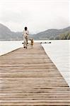 Pregnant Woman Running on Dock With Her Dog