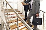 Business people on office staircase