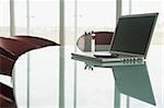 Laptop with cell phone on conference table