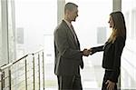 Businessman and businesswoman shaking hands