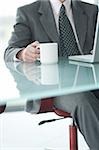 Businessman at laptop computer with coffee cup