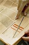 Hands holding newspaper with chart analyzing financial crisis