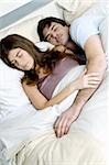 Young couple in bed sleeping