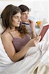 Young couple in bed relaxing