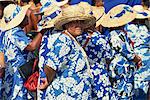 Portrait of a group of women in blue and white dresses, wearing straw hats, in a parade on Independence Day in Apia, on Upolu, Western Samoa, Pacific Islands, Pacific