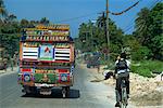 Local bus and cyclist, Port au Prince, Haiti, West Indies, Central America