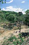 Houses and people walking in dry river bed caused by erosion, near Petionville, Haiti, West Indies, Central America