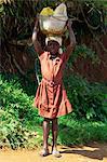 Portrait of a young girl carrying water containers on her head, Haiti, West Indies, Caribbean, Central America