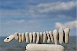 Balancing rocks in a row on the beach