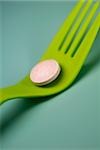Close-up of a pill on a fork