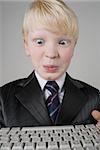 Close-up of a boy holding a computer keyboard