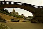 Arch bridge on the beach and a cathedral in the background, Port Des Pecheurs, Eglise Sainte Eugenie, Biarritz, France