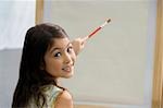 Portrait of a schoolgirl painting in an art class