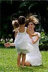 Young woman playing with her daughter in a park