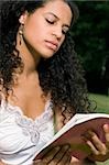 Close-up of a teenage girl reading a book