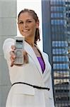 Portrait of a businesswoman showing a mobile phone and smiling