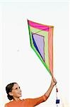 Girl flying a kite and smiling