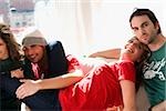 Two young couples sitting on a couch