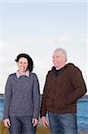 Couple standing on the beach and smiling