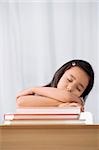 Schoolgirl sleeping at a desk in a classroom