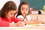 Two schoolgirls painting in an art class