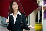 Close-up of a businesswoman holding an umbrella